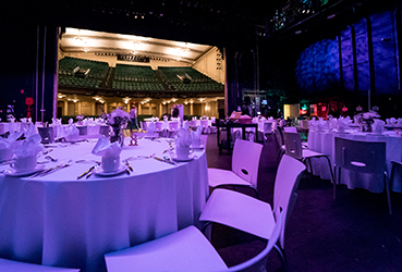 Tables set up for a reception on the stage of the Victoria Theatre