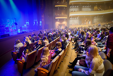 Students waiting for a performance to begin at the Schuster Center
