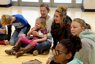 Kids and teens sitting on the floor at the PNC Arts Annex