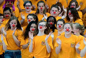 Girls with red clown noses clapping