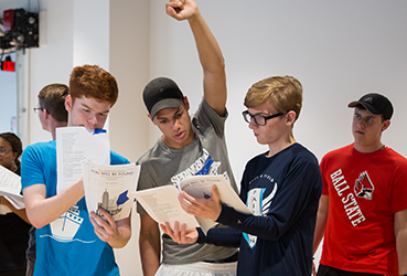 Students looking at scripts
