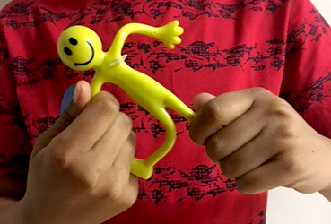 Hands of child playing with a bending toy