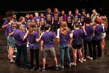 Broadway After School participants gather after a performance.