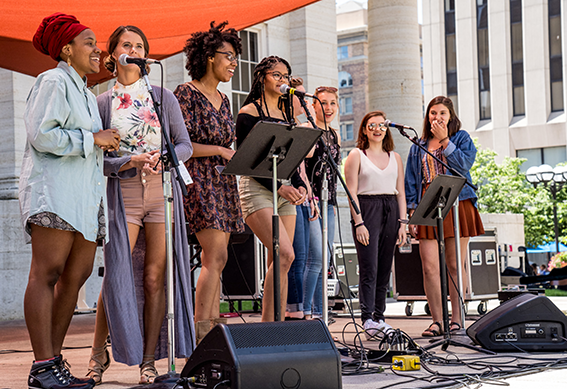 Women Who Rock performers sings on stage.