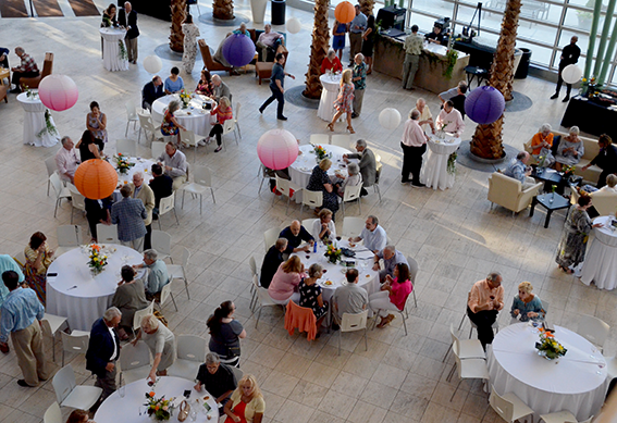 People sitting at tables at an event in the Schuster Center Wintergarden